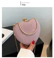 Detail of pink heart-shaped clutch bag with glitter texture and gold metal snake handle - Pink
