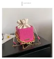 Detailed close-up of pink checkered bucket bag with gold chain and drawstring closure - Pink