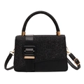 Black glitter handbag with gold buckle and adjustable strap on a clean white background - Black