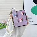 Detailed view of Samsung Z Flip6 purple leather case with pearl chain and rabbit motif - Purple Cross-Grain Tulip Rabbit Ear With Pearl Chain / Samsung ZFlip3