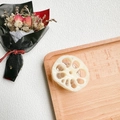 Detail view of a creative lotus root slice phone grip on a rustic wooden tray setup - 3D Lotus Root