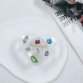 Detail of heart-shaped phone grip featuring colorful rhinestones and gold Diamonds text - Drip Glue Heart Stand-Colorful Gems-Laser Green