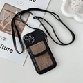 Detail of black crossbody phone case with brown fabric card slot and gold metal hooks - Textured Black / 15 Pro Max