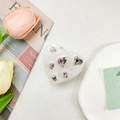 Detail of a heart-shaped resin phone stand with inlaid pink and clear crystal gems - Drip Glue Stand - Pearlescent Gem - White