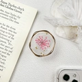 Detailed view of phone socket grip featuring pink dried flower and golden wavy metallic edge - Resin Stand - Twisted Ring Real Flower / Pink