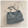 Close-up of blue-grey textured chain tote bag with metal bar detail and flap closure - Light Blue