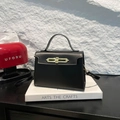 Sac à main élégant en cuir noir avec fermoir doré sur boîte blanche pour le bureau - Noir