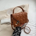 Chic brown quilted crossbody bag with golden buckle and adjustable leather strap - Caramel color
