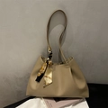 Elegant beige pleated tote bag with silk scarf handle on minimalist gray background - Khaki