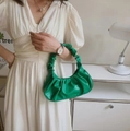 Vibrant green pleated baguette bag in glossy faux leather with a stylish croissant silhouette - Green