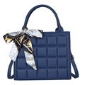 Dark blue quilted square handbag with floral silk scarf and adjustable strap on white background - Blue
