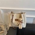 Chic beige tote bag with brown straps and a cute knitted bear charm on a dark leather surface - Bear Style Brown