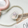 Detail of expandable phone grip with purple beads and white pearl inside clear shell - Purple Eye Pink (100052)