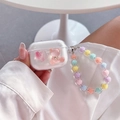 Close-up of clear AirPods Pro case with pink glitter heart and bear charm on beaded strap - Transparent Jelly Bear Heart with Multicolor Bead Chain / 1st/2nd Gen Universal