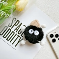 Detailed view of plush black monster phone socket with a beige knit hat and fuzzy limbs - Plush Stand - Little Devil - Black