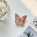 Dettaglio del supporto per telefono a farfalla arancione con glitter e paillettes a stella - Supporto Trasparente / Farfalla Sabbie Mobili - Arancione