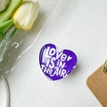 Macro shot of purple heart-shaped phone grip with Love Is In The Air text on white texture - Crystal Glass Love Heart Dark Purple