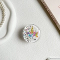 Close-up of round phone grip featuring a colorful unicorn with sparkling star sequins - Colorful Unicorn Style (100140)
