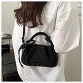Detail of black pleated crossbody bag with heart pendant and textured cord accent - Black without Pendant
