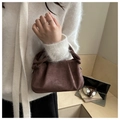 Detail of a mini dark brown suede handbag featuring natural pleated design and rounded handle - Coffee No Charm