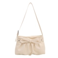 Cream white PU leather shoulder bag with bow and silver star studs on plain white background - White
