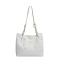 White minimalist tote bag featuring silver star patterns and golden chain strap detail - White