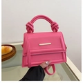 Minimalistische rosa Umhängetasche mit Knotengriffen und goldenen Metallakzenten - Rosarot