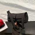 Black nylon crossbody bag with dual front pockets and adjustable wide shoulder strap - Black