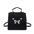 Fashionable black matte backpack featuring a metallic silver butterfly bow detail - Black