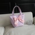 Lavender tote bag with silver star pattern and large pink satin bow on a sofa - With Bow / Purple