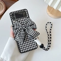 Detail of Galaxy Z Flip case featuring black and white houndstooth pattern and a large bow - Houndstooth Bow - Matching Lanyard / Samsung ZFlip3