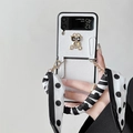 Leather Samsung Z Flip case with diamond bear ornament and black-white ribbon strap - Cross Pattern-Heart Bow Bear-Polka Dot Scarf Handle (ZFlip3)