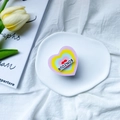 Colorful heart-shaped phone griptok with Bonjour text on a white ceramic plate - Pink Heart (BONJOUR)