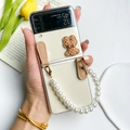 Detail of transparent Galaxy Z Flip case with a brown bear ornament and pearl handle - Bear Style (Z Flip 5)
