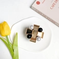 Detailed shot of a vintage gold cross phone grip with pearls on a white ceramic tray - Metal Stand-X Pearl-Gold Black