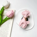 Detail of pink leather giraffe phone grip with gold heart charm and fine stitching - Pink