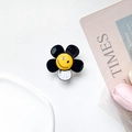 Dettaglio del supporto per telefono a forma di fiore bianco e nero con faccina sorridente - Nero
