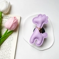 Detail of a purple leather giraffe phone grip with gold charm on a ceramic tray - Purple