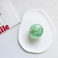 Green transparent donut phone socket with colorful candy bead accents on a white tray - Jelly Green