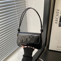 Minimalist black patent leather underarm bag with glossy finish and knotted strap - Black