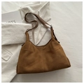 Detail of a brown suede crescent bag with vertical stitching on a white corduroy fabric - Brown