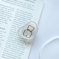 Dettaglio del supporto per telefono a orsetto con base trasparente su un libro chic - Supporto per Anello di Perla - Orso Magro Cavo - Oro