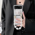 Detail showing white camellia flower with pearls and rhinestone on Samsung Z Flip case - White / Samsung Z Flip3