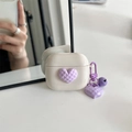 Detail of off-white earbud case with purple heart charm and metal bell accessory - Purple Grid Heart - Apricot / AirPods 1/2 Gen