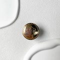 Detail of a round gold metallic phone grip featuring a relief bear and wave edge design - Round Bear / Gold