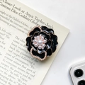 Supporto cellulare a fiore in smalto nero con bordi dorati e perle su una rivista - Nero