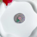 Close-up of a round rhinestone phone grip with a pink flower on a ceramic tray - Sparkling Diamond Stand-Tulip-Pink