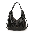 Glossy black versatile backpack and shoulder bag with metallic logo on white background - Black