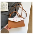 Detail of brown leather handbag with pink bear print on grey suit with Matisse book - Cartoon Bear and Red Heart / Brown