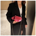 Irregular fuchsia acrylic evening bag with gold chain strap on a black suit - Rose Red